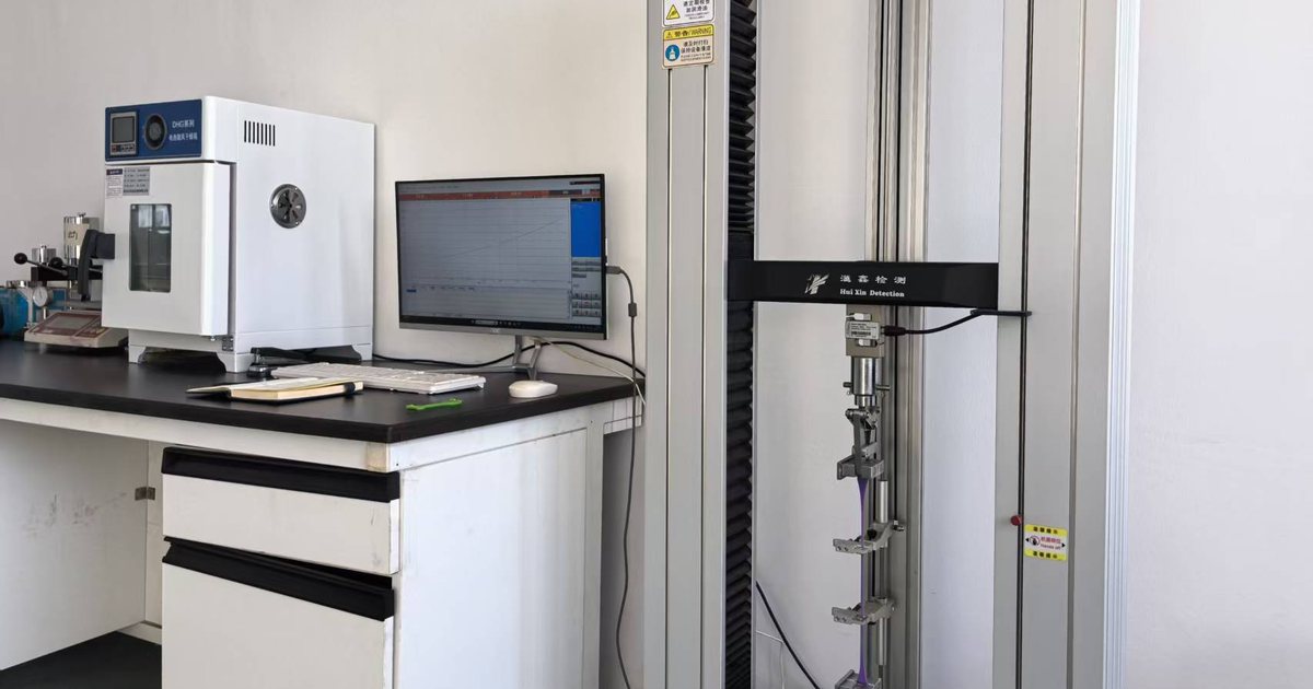 Resistance band testing bench with drying oven and tensile tester used to check sticky bands and oil bleed
